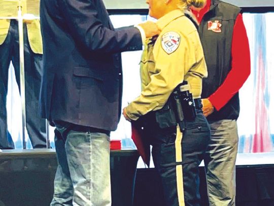 Freestone County Sheriff Jeremy Shipley pins a badge on Deputy Emilee Allen at her graduation ceremony on Saturday, Jan. 18. Courtesy Photo
