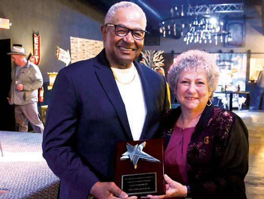 Tony Brackens Sr. receives the Legacy Award from Mary Small. Photo by Mitchell Pate/Recorder-Chronicle