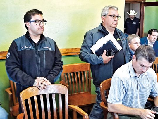 Fairfield Fire Chief Anthony Roberts, left, is accompanied by personnel from a company called Forecaster at the Commissioners Court’s Nov. 20 meeting, who gave details about a new fire truck the county ultimately approved purchasing for the Fire Department. Photo by Roxanne Thompson/with t...