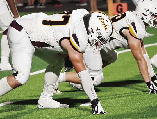 Brayden Thornburg and John Macke get down and ready to play defense for the Eagles.