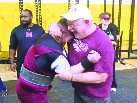 Landon Salinas gives his Coach, Kevin Childers, a hug as they celebrate his personal best of 550 pounds on bench press at the Darrell Piske Memorial Powerlifting Meet in Fairfield on Thursday, Jan. 30. Salinas won his division, lifting a total of 1,815 pounds. Photo by Mitchell Pate/Fairfi...