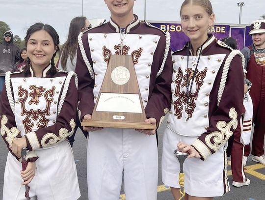 Fairfield Drum Majors Brooke Cobb, Jerry Draper, and Zada Pjetrovic show off the trophy the Grand Band from Eagleland won on Wednesday, Oct. 15, at the Region 8 Marching competition to advance to the state competition on Wednesday, Oct. 30. Courtesy Photo