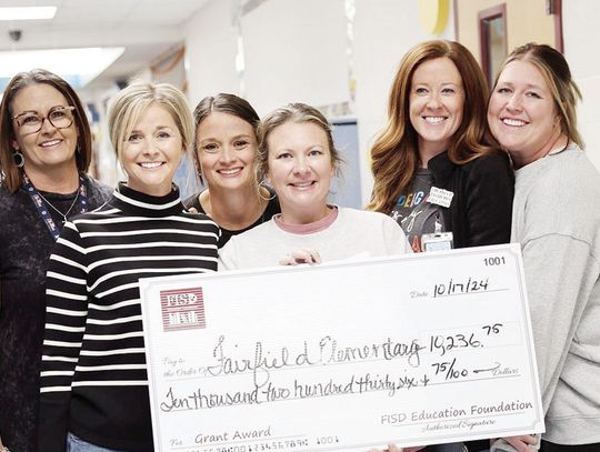 Wendy Farrell, Kelly Wren, Emily Beaver, Megan Jones, Molly Griffin, and Ann Ballew receive a grant for $1,200 for books and scoop chairs. Fairfield Elementary received a total of $10,236.75 in grants.