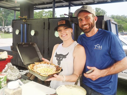 Amy and Brett Nicholas of Dickinson make crab claws with a cheese sauce. Photo by Mitchell Pate/ Fairfield Recorder