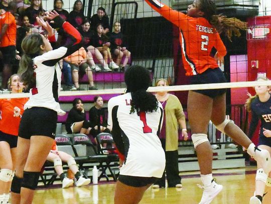Teague middle blocker Bethanah Owens (2) attempts a volley at the net in Tuesday’s road match against Mexia.