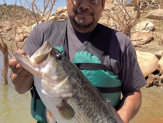 Ross Gomez with the 13.22-pound Toyota ShareLunker he caught while fishing from the public dock at Sam Wahl Recreation Area on Lake Alan Henry in February 2023. The fish produced nearly 34,000 fingerlings during its brief stay at the TFFC and was released back into Alan Henry the following...