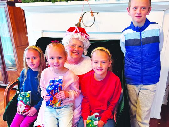ABOVE TOP: Olivia Allen, Faith Allen, Abigail Allen and Benjamin Allen pose for a photo with Mrs. Claus at Merry Memories at the Moody Bradley House on Saturday afternoon, Dec. 7. Photo by Daryl Allen/Fairfield Recorder
