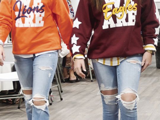 JJ Bates and Rylie Swinson show off their Teague Lions and Fairfield Eagles sweatshirt from The Jaded Spade. They both have on a white button up underneath paired with Flying Monkey Jeans. Swinson is also wearing maroon and gold shoes from The Jaded Spade. See more photos, Page 3. Photos b...