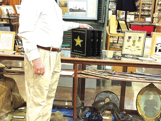 Dr. Ronnie. E. Erwin stands in the Freestone County Historical Museum after donating a copy of his book, “Stars Over Texas.” Contribute photo