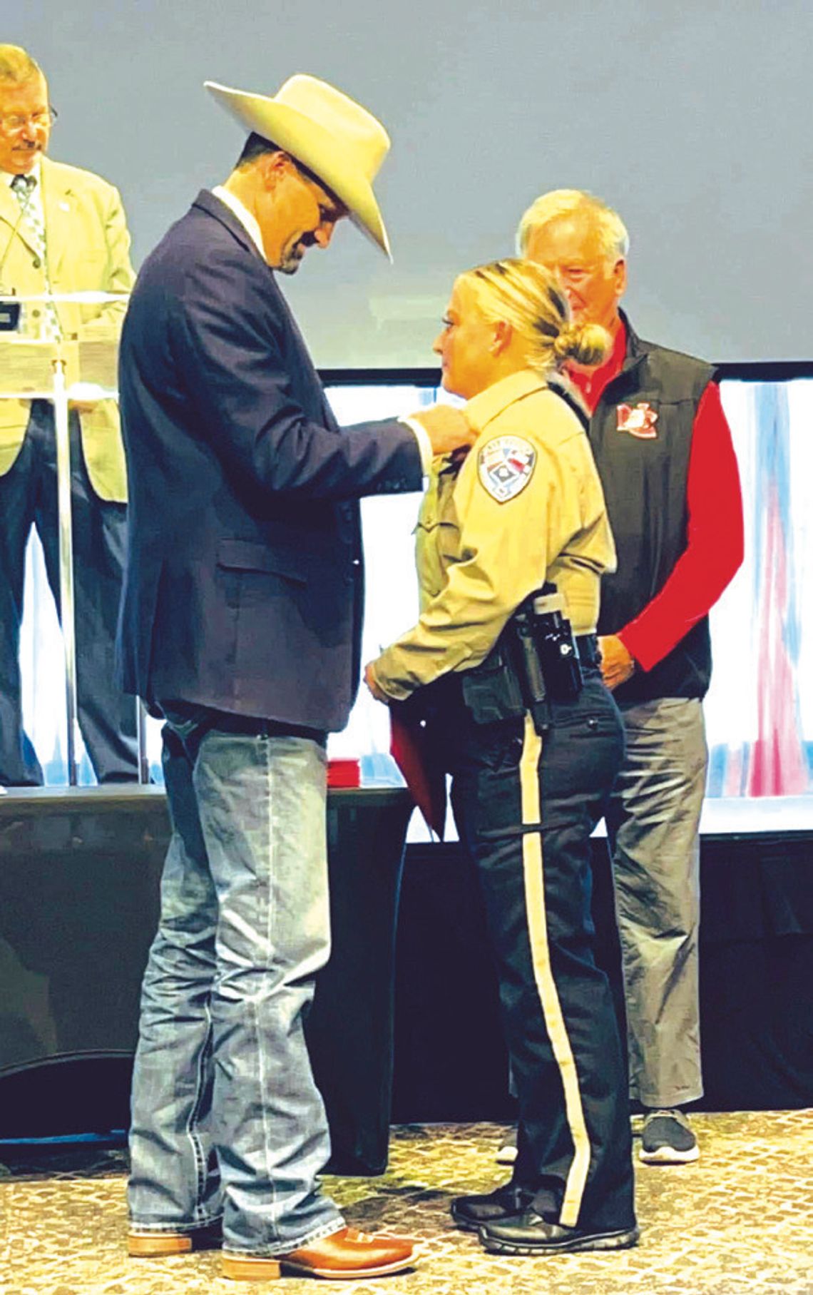 Freestone County Sheriff Jeremy Shipley pins a badge on Deputy Emilee Allen at her graduation ceremony on Saturday, Jan. 18. Courtesy Photo
