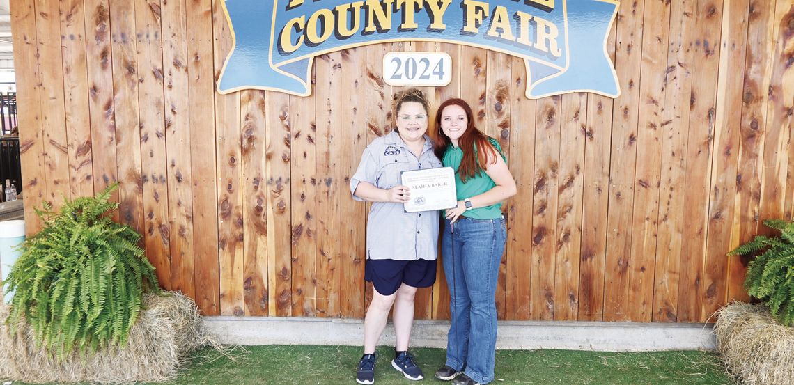 Olivia Hays presents Alaina Baker with the Kindness from Case belt buckle at the 2024 Freestone County Fair. Photo by Mitchell Pate/Fairfield Recorder