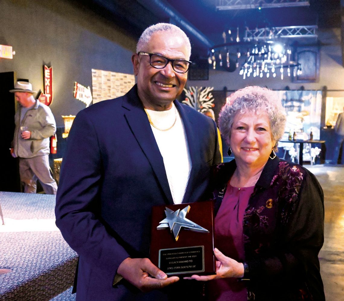 Tony Brackens Sr. receives the Legacy Award from Mary Small. Photo by Mitchell Pate/Recorder-Chronicle