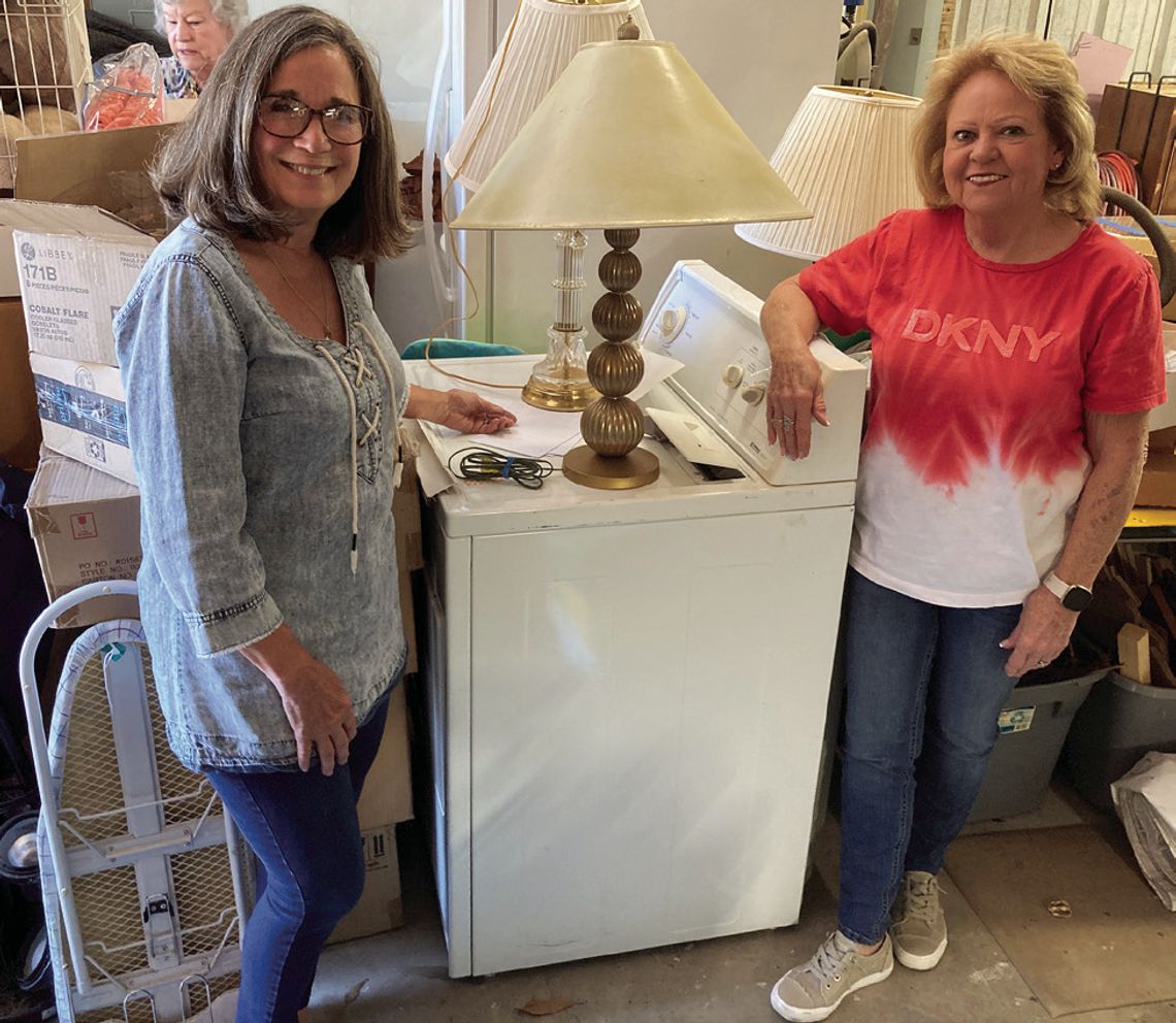 Community Club Care members Sandi DeLoach and Joy Olk check out a dryer and two of many lamps for the household part of the SuperSale. Drop-off day is April 25, and sale day is April 26. Courtesy Photo