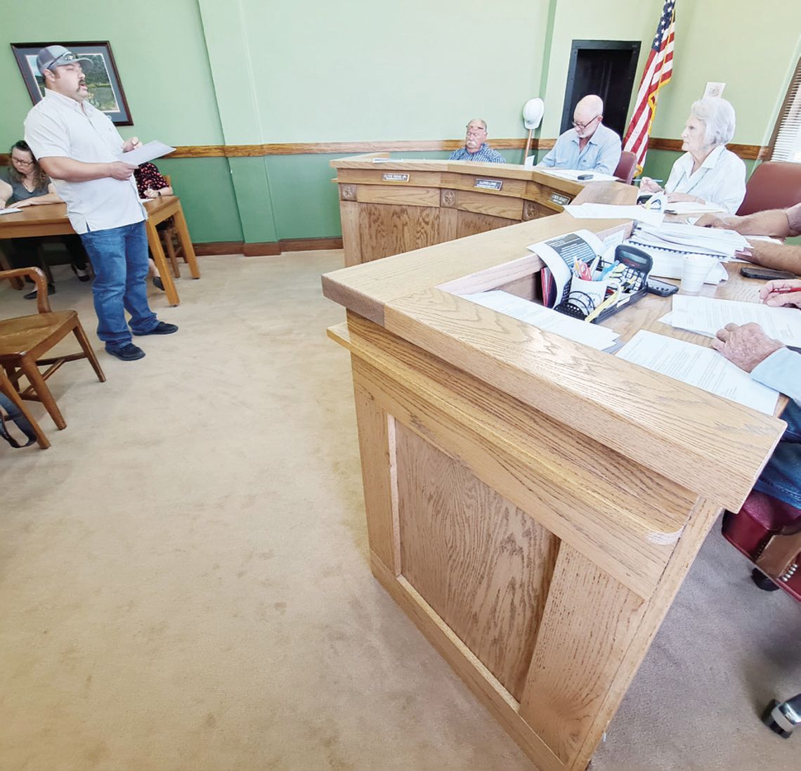 Freestone County Emergency Management Coordinator Leonard Smith, at left, tells Freestone County Commissioners Court at its June 27 meeting what he learned at a special meeting about qualifying for the FederalDisaster Declaration for the severe weather that began April 26. At right can be...