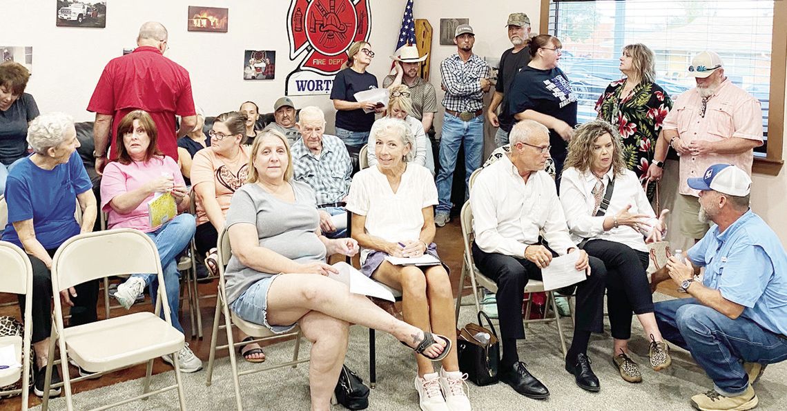 Wortham residents attending a special City Council meeting Monday, Aug. 12, where the recent, sudden retirement of longtime Chief of Police Kelly Butler was discussed, chat with each other during a closed session of the council. Photo by David Webb/The Mexia News