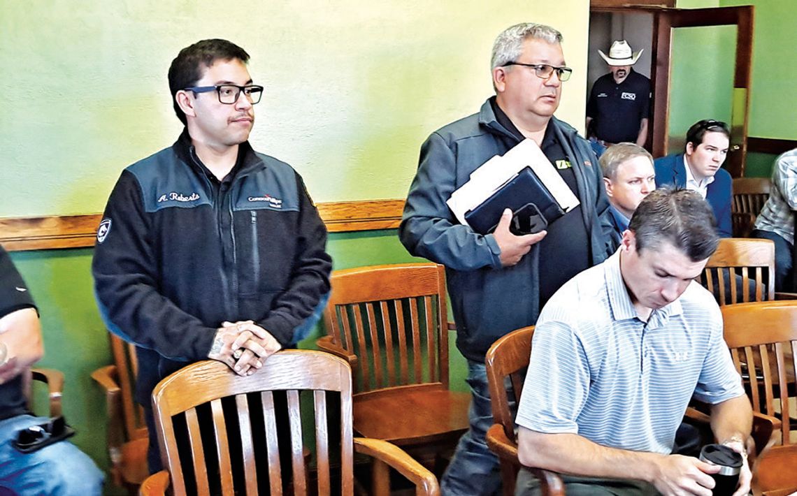Fairfield Fire Chief Anthony Roberts, left, is accompanied by personnel from a company called Forecaster at the Commissioners Court’s Nov. 20 meeting, who gave details about a new fire truck the county ultimately approved purchasing for the Fire Department. Photo by Roxanne Thompson/with t...