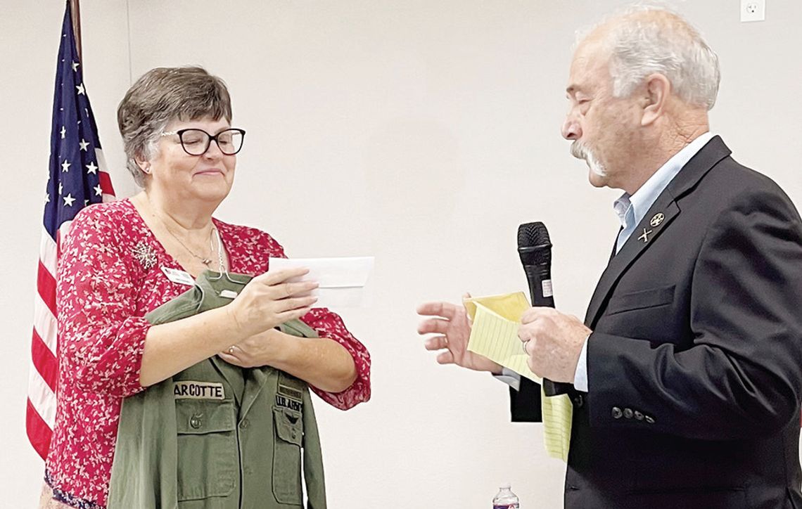 Ed Marcotte presents a check for $1,876 to Wreaths Across America Chair Beth Harrison that represents a donation from Limestone and Freestone Counties Masons for the organization’s work. Harrison holds a U.S. Army jacket worn by Marcotte’s uncle.