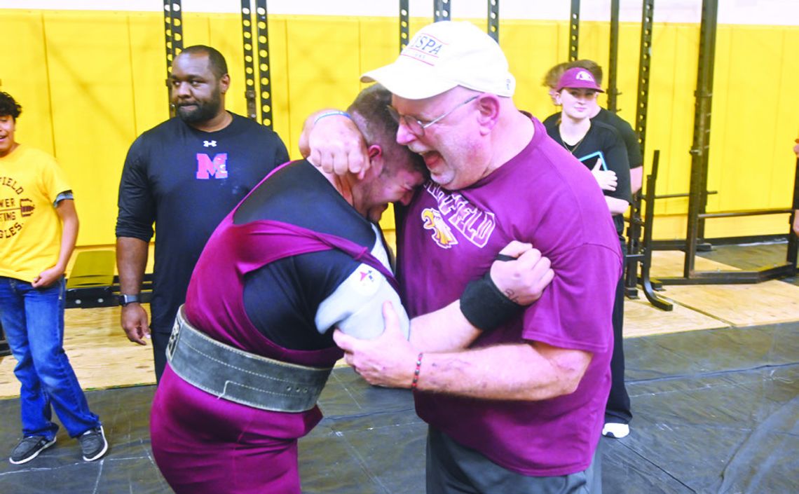 Landon Salinas gives his Coach, Kevin Childers, a hug as they celebrate his personal best of 550 pounds on bench press at the Darrell Piske Memorial Powerlifting Meet in Fairfield on Thursday, Jan. 30. Salinas won his division, lifting a total of 1,815 pounds. Photo by Mitchell Pate/Fairfi...