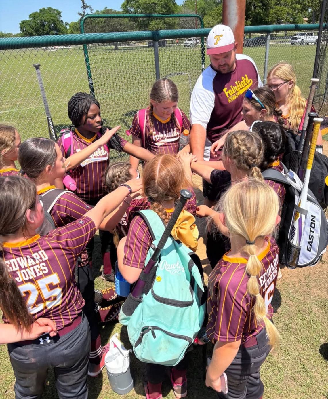 TOP: The Lady Eagles gather as a team on Saturday, April 12, during their opening day ceremony.