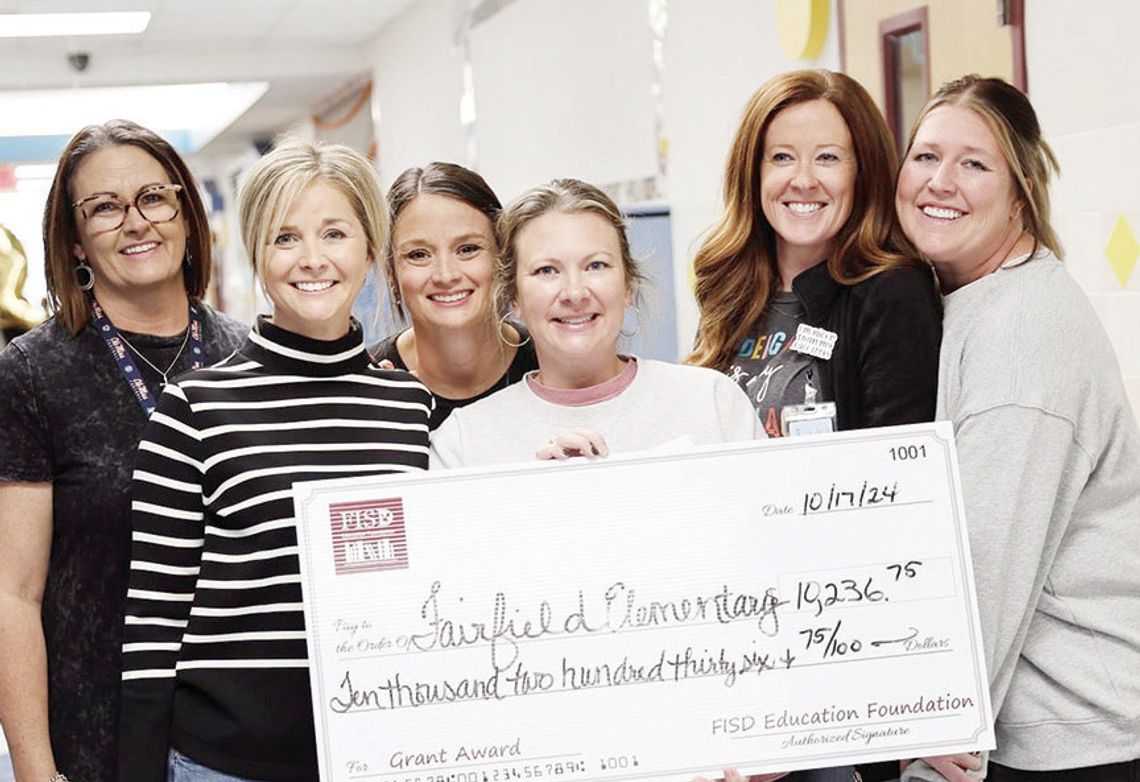 Wendy Farrell, Kelly Wren, Emily Beaver, Megan Jones, Molly Griffin, and Ann Ballew receive a grant for $1,200 for books and scoop chairs. Fairfield Elementary received a total of $10,236.75 in grants.