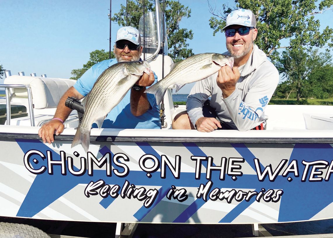 Brett Kilmer (left) and Casey Laughlin with Chums on the Water Guide Service show off a couple of hybrid stripers landed with Luke last week at Lake Tawakoni. Photo by Luke Clayton