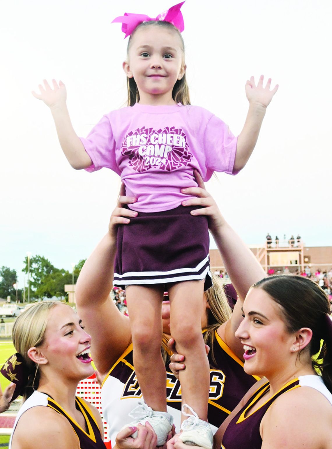 Delilah Phillips is boosted into the air by some high school cheerleaders. She was one of the many youngsters cheering on the Eagles against Mexia on Friday night. Photo by Mitchell Pate/Fairfield Recorder