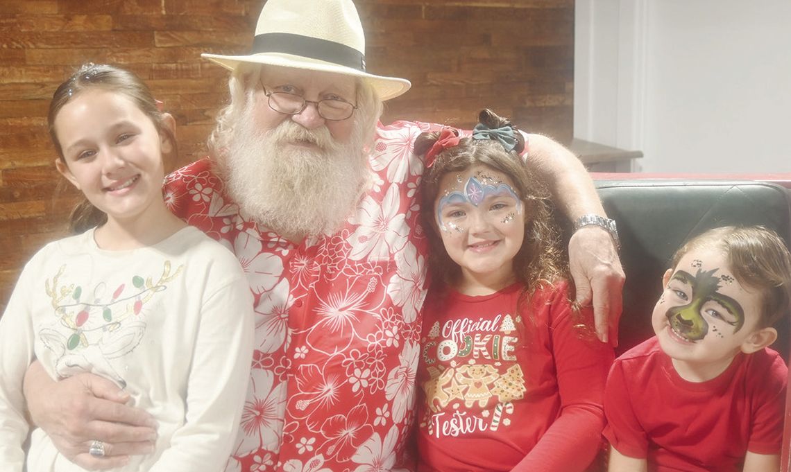 Siblings 9-year-old Nessie Alanis, 7-year-old Adeline Alanis and 3-year-old Walton Alanis visit with Santa at the Green Barn on Saturday morning, Sept. 28, during Breakfast with Santa, hosted by the Fairfield Chamber of Commerce.