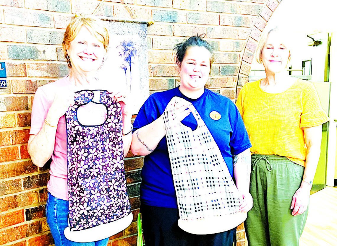 ABOVE, Diane Pullin and Theresa Zachary present bibs to a Teague Nursing Home employee. BELOW, Thressa Ivy, Cindy Neal, Theresa Zachary, Pam Windham, and Dianne Murden present bibs to Fairfield Nursing and Rehab employees.