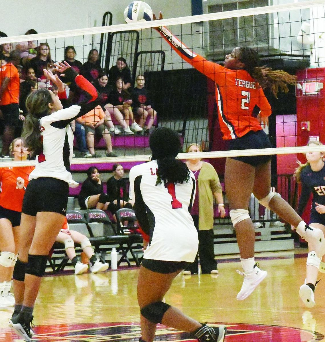 Teague middle blocker Bethanah Owens (2) attempts a volley at the net in Tuesday’s road match against Mexia.