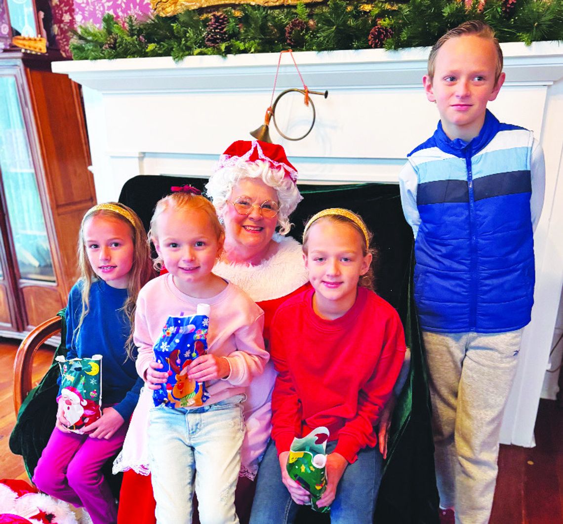 ABOVE TOP: Olivia Allen, Faith Allen, Abigail Allen and Benjamin Allen pose for a photo with Mrs. Claus at Merry Memories at the Moody Bradley House on Saturday afternoon, Dec. 7. Photo by Daryl Allen/Fairfield Recorder