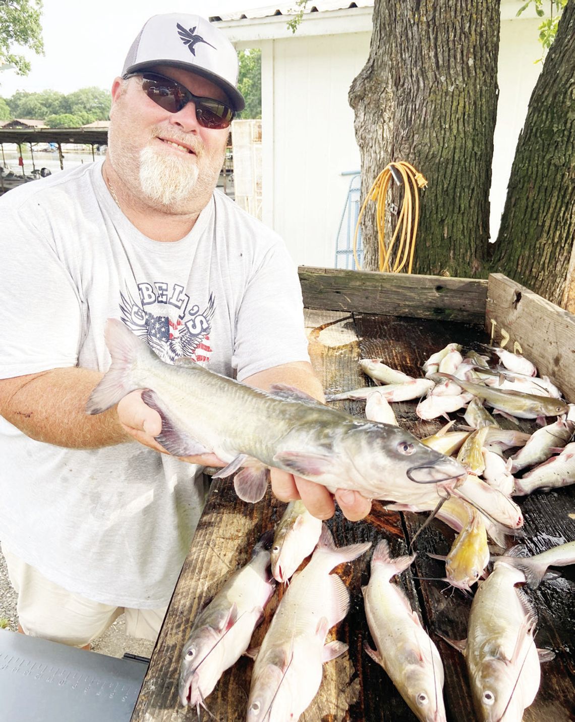 Cedar Creek Lake guide Jason Barber with a good ‘mess’ of channel catfish he and Luke landed using cane poles and fishing off the bank. Courtesy Photo