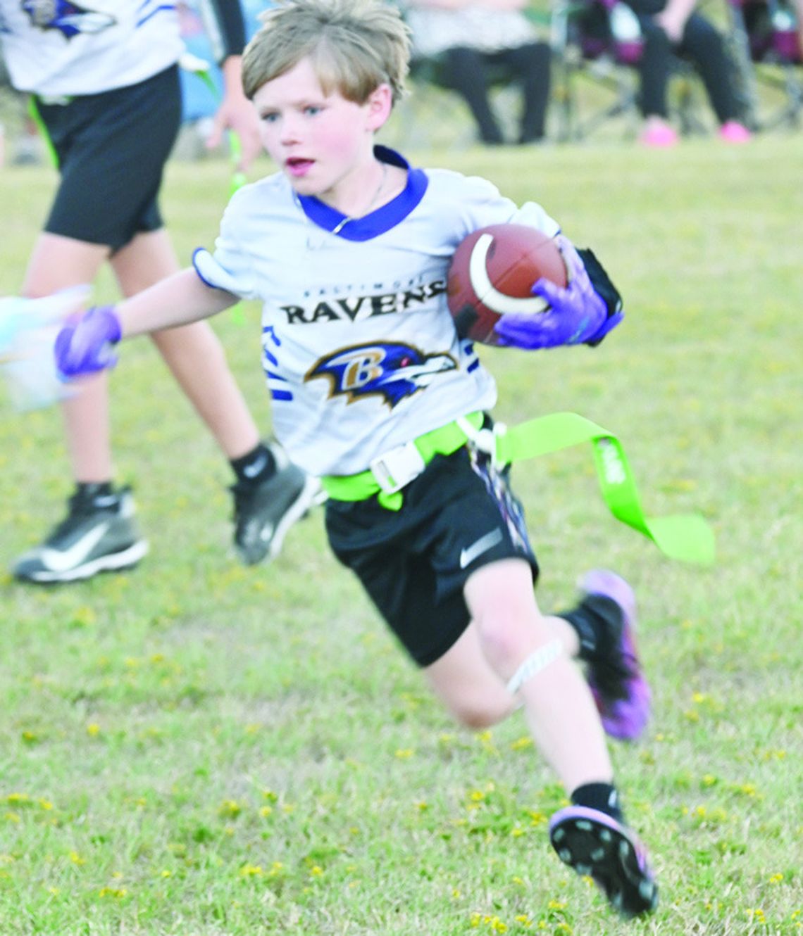 Rush Combs picks up some yardage for his team during Eagle Flag Football action on Monday night