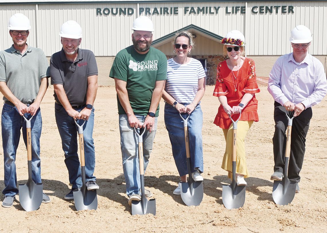 Worship Pastor Chris Owen, Student Pastor Leon Thomas, Lead Pastor Chris George and wife Julie George, Children Ministry Team Coordinator Betsy Wright, and Discipleship Pastor Jeff Wright break ground for the new Round Prairie Baptist Church building on Sunday, Aug. 25. Photo by Mitchell P...
