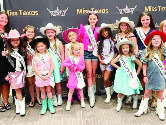 Director Emily Goodson and Texas Lone Star Princesses Stanlee Jo Hamilton, Savannah Fulmer, Laney Lehman, Madison Helfenbein, Gracie Franco, Kelsie West, Harleigh DeBorde, Meia Gilley, Harper Easter, Selah Smith, Kyler Ann Holcomb, Amelia Solley, and Hayl